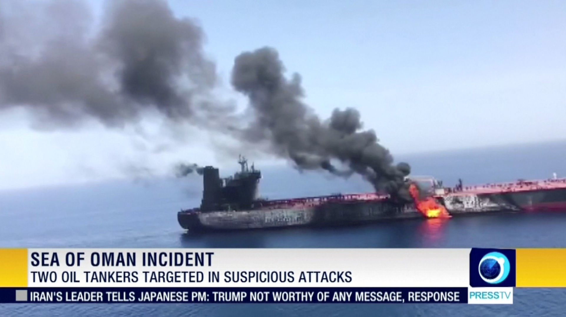 Still image taken from a video appears to show two tankers at sea, one of which has a large plume of dark smoke in the Gulf of Oman
